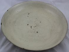 A large Chinese cream glazed dish, Ming dynasty, with fine crackle to the cream glaze, brick red