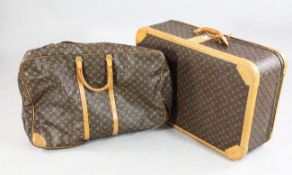 A Louis Vuitton suitcase, with stitched tan leather borders and three barrel combination lock,