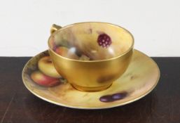 A small Royal Worcester fruit-painted tea cup and saucer, c.1926, the interior of the cup painted by