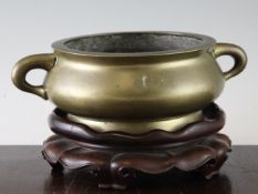 A large Chinese bronze gui censer, Xuande mark, 19th century, of squat baluster form with a pair