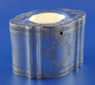 A large Victorian silver tea caddy, of lozenge form, with engraved decoration with two vacant