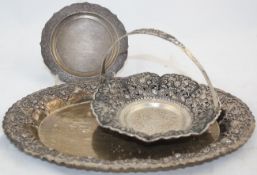 An Indonesian Yogya oval dish and a similar bon bon basket, early 20th century, both embossed with