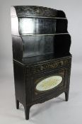 A Regency black japanned and parcel gilt waterfall bookcase, decorated all over with urns, floral