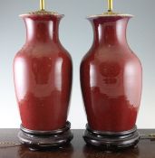 A pair of Chinese sang-de-boeuf baluster vases, 19th / 20th century, mounted as lamps, with wood