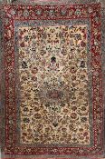 An Isfahan rug, with central foliate motif, in a field of scrolling foliage, on an ivory ground,