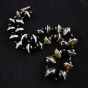 An Edwardian graduated banded agate bead necklace, with gold barrel shaped clasp, 16.75in.