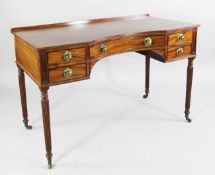A 19th century mahogany writing table, the single concave frieze drawer between two smaller drawers,