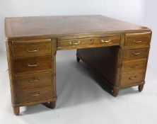 An early 20th century Continental walnut partner`s desk, with leather inset top over nine drawers