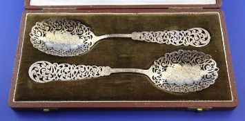 A cased pair of late Victorian silver spoons, with pierced handles and bowls, A.Willis & Co,