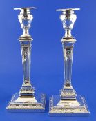 A pair of George V silver candlesticks by William Hutton & Sons, with square tapering stems and