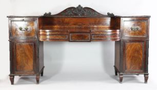 A large George III mahogany pedestal sideboard, with shaped floral carved gallery back, the dipped