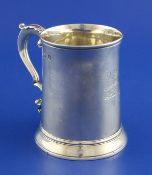 A George III silver mug, with engraved armorial and acanthus leaf capped scroll handle, I.?, London,