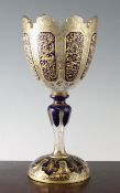 A Bohemian overlaid glass goblet shaped vase, 19th century, overlaid in cobalt blue on a clear