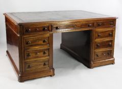 A late 19th century Continental mahogany partner`s desk, the leather inset top with three frieze