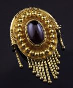 A Victorian gold and cabochon almandine garnet set oval tassel brooch, now with pendant mount and