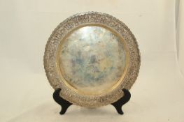 An Indonesian Yogya silver petal rimmed dish, early 20th century, the border embossed and chased