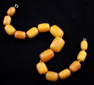 A single strand graduated barrel shaped amber bead necklace, with rolled gold clasp, gross 120