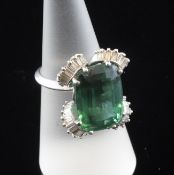 An 18ct white gold, green tourmaline and diamond dress ring, the large cushion cut tourmaline with