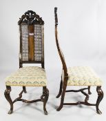A pair of Queen Anne style walnut high back chairs, with caned panels and over-stuffed seats, on