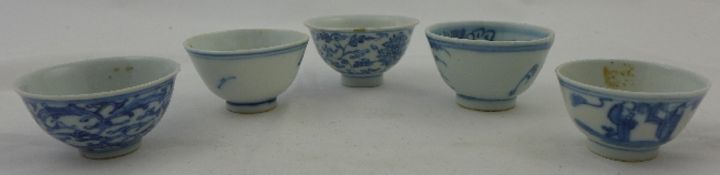 A group of five Chinese blue and white cups, 18th / 19th century, the first painted with lotus