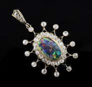 An 18ct gold, black opal and diamond pendant, of oval form, with diamond set starburst border, 1.
