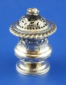 A George IV silver pepperette, of urn form and embossed with floral scrolls, with rose finial,