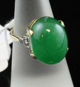 An 18ct gold and platinum, cabochon jadeite and diamond set ring, of oval form, size L.
