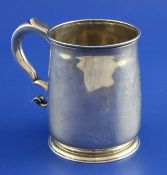 A George I silver mug by Thomas Farren, with engraved armorial and scroll handle with engraved