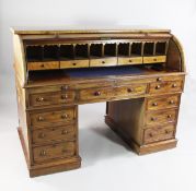 A Victorian mahogany pedestal cylinder bureau, with fitted interior and slide out writing surface