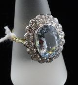 An 18ct gold, aquamarine and diamond oval cluster ring, the central stone approximately 4.50cts.