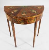 A Sheraton Revival satinwood and painted demi lune folding card table, decorated with acanthus