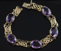 An early 1970`s 9ct gold and amethyst bracelet, set with five oval cut amethysts, 7.75in.