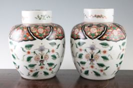 A pair of Chinese famille verte ovoid jars and covers, late 19th century, each painted with scrolls,