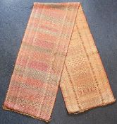 An Indonesian ceremonial gilt metal thread songket cloth, Sumba, 20th century, the red ground with