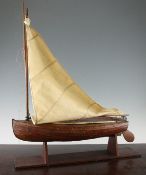 A model of a small Gunter rigged sailing dinghy, on stand, 21in.