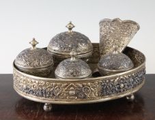 A Malaysian silver tepak sirih, early 20th century, each piece embossed and chased with flowers