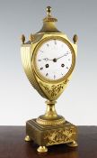 A French Empire ormolu urn shaped mantel clock, the enamelled dial signed M. Busy Pere & Fils,