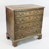 A George III mahogany straight front chest, of four long graduated drawers with brushing slide, on