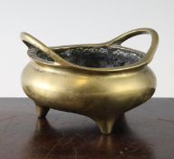 A Chinese bronze tripod censer, Xuande mark, 19th century, the pair of high looped handles above the
