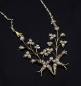 An Edwardian 15ct gold and seed pearl set drop necklace, modelled as two central swallows flanked by