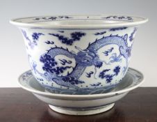 A Chinese blue and white `dragon` jardiniere and stand, late 19th / early 20th century, painted with