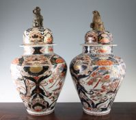 A pair of Japanese Arita ovoid jars and covers, 18th century, each painted with phoenixes perched on