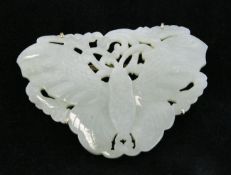 A Chinese pale celadon jade `butterfly` plaque, 19th century, with pierced scrollwork leaf sprigs