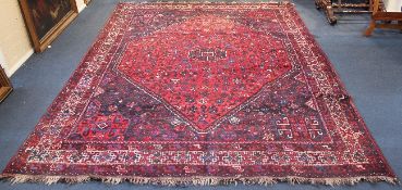 A Shiraz carpet, with field of geometric motifs, figures and animals within a central stepped