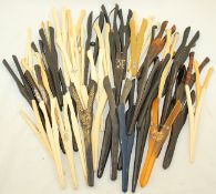 A collection of various antique and vintage glove stretchers, including examples in ivory, bone,