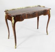 A Victorian rosewood writing table, the serpentine top with pierced three quarter gallery and single