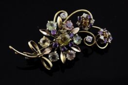 A gold, diamond and multi gem set floral spray brooch, including amethyst and tourmaline, 2.25in.