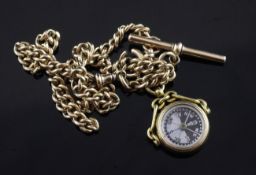 A 15ct gold curb link albert hung with an 18ct gold and bloodstone swivelling compass fob, chain