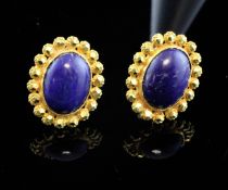 A pair of 22ct gold and lapis lazuli ear studs, of oval form, with facetted beaded border, 0.75in.