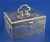 An early 20th century Japanese silver trinket box, of rectangular form, engraved with chrysanthemums